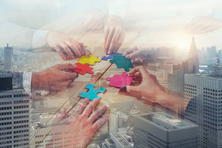 Photo for Business people connect pieces of puzzle like a teamwork and partners - Royalty Free Image