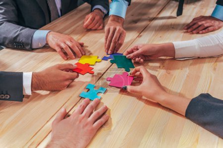 Photo for Business people connect pieces of puzzle like a teamwork - Royalty Free Image