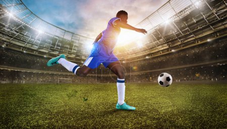Téléchargez les photos : Football player chases a soccerball at the stadium - en image libre de droit