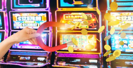 Téléchargez les photos : Big magnet attracts money in a casino by gambling - en image libre de droit
