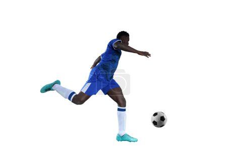 Foto de Jugador de fútbol con traje de equipo azul persigue la pelota de fútbol - Imagen libre de derechos