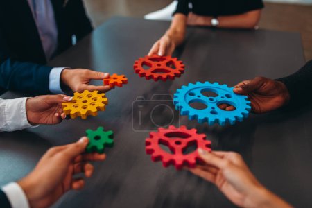 Photo for Businesspeople connect pieces of gears. Partnership and integration concept - Royalty Free Image
