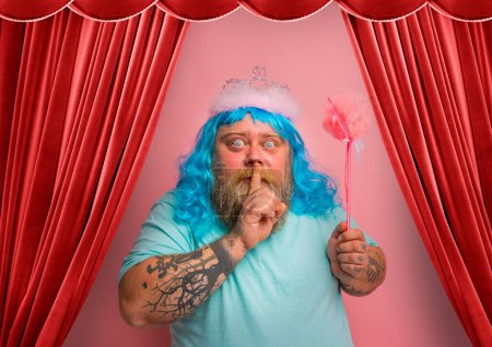 Photo for Fat serious man with tattoos acts like a fairy - Royalty Free Image