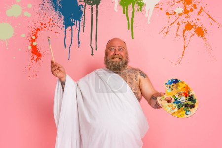 Photo for Fat man acts like an important artist with brush in hand - Royalty Free Image