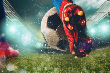 Soccer player kicks the ball vigorously at the stadium