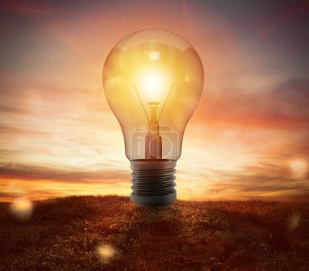 Photo for Big lightbulb in a field during the sunset - Royalty Free Image