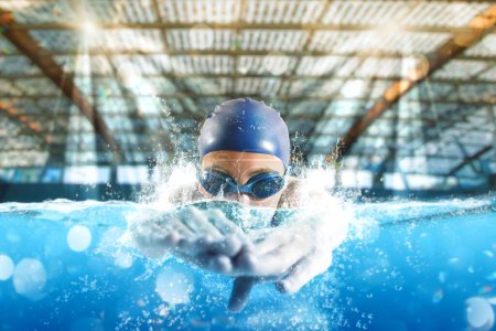 Photo for Sporty woman with goggles swims fast during a sport competition - Royalty Free Image