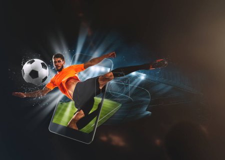 Foto de Soccer players, cellphone and ball on a stadium - Imagen libre de derechos