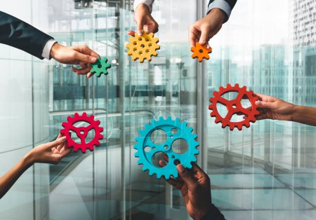 Photo for Business people connect pieces of gears like a teamwork and partners - Royalty Free Image