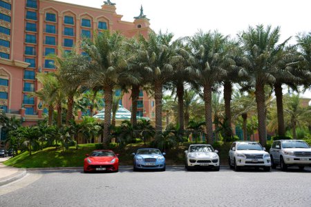 Photo for DUBAI, UAE - SEPTEMBER 11: The Atlantis the Palm hotel and limousines. It is located on man-made island Palm Jumeirah on September 11, 2013 in Dubai, United Arab Emirates - Royalty Free Image