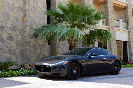 Photo for DUBAI, UAE - SEPTEMBER 9: The luxury Maserati Granturismo car is near luxurious hotel on September 9, 2013 in Dubai, United Arab Emirates. Hotels in Dubai attracted over 11 million guests in 2013. - Royalty Free Image