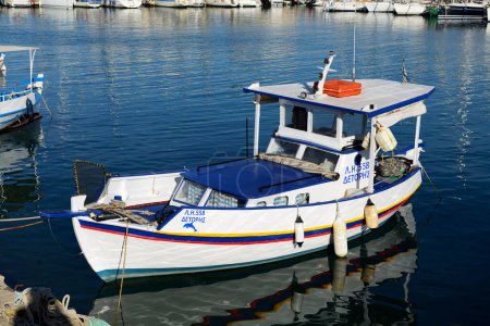 Photo for HERAKLION, GREECE - MAY 12: The traditional Greek fishing boat is near pier on May 12, 2014 in Heraklion, Greece. Up to 16 mln tourists is expected to visit Greece in year 2014. - Royalty Free Image