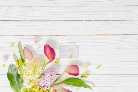 Photo for Beautiful flowers on white wooden background - Royalty Free Image