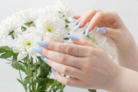 Photo for Female hands with beautiful manicure and chrysanthemum flowers - Royalty Free Image