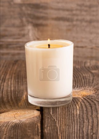Photo for Burning candle in glass on wooden background - Royalty Free Image