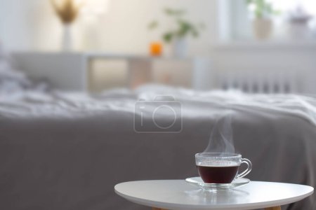 Téléchargez les photos : Tasse de café en verre sur table blanche dans la chambre - en image libre de droit