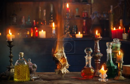 Photo for Old burning paper with potions on old wooden table - Royalty Free Image