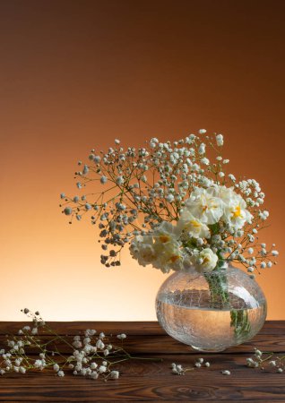 Photo for White flowers in glass vase on wooden table - Royalty Free Image