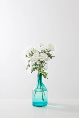 Photo for White  chrysanthemums in  glass vase on white  background - Royalty Free Image