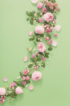 Photo for Pink flowers and green leaves on green background - Royalty Free Image
