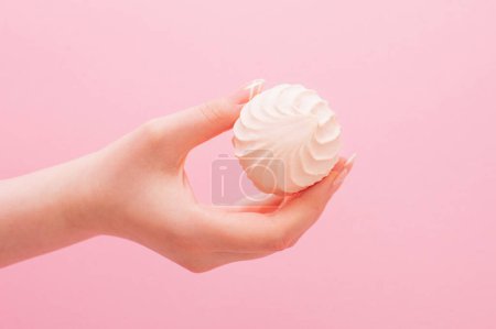 Photo for Female hands with zephyr on pink background - Royalty Free Image
