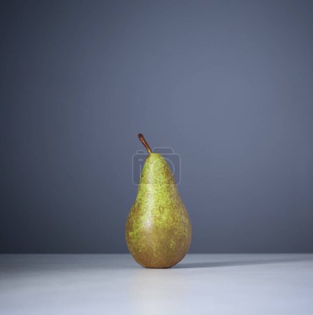 Photo for Pear on table on background blue wall - Royalty Free Image
