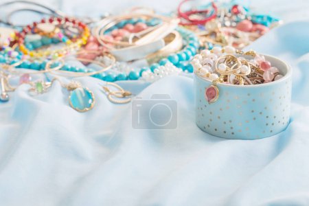Photo for Different women's jewelry on blue fabric - Royalty Free Image
