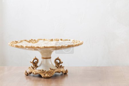 Photo for Clean vintage big cake plate on wooden table - Royalty Free Image