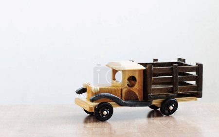 Photo for Vintage wooden homemade car on wooden table on white background - Royalty Free Image