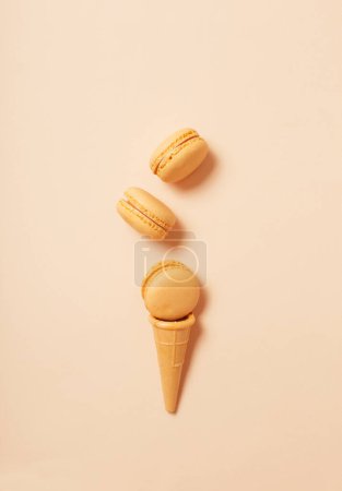Photo for Waffle cone with macaroon on paper background - Royalty Free Image