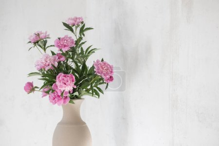 Photo for Pink peony in ceramic vase on background old wall - Royalty Free Image