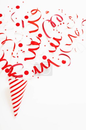 Photo for Striped birthday hat with confetti on white background - Royalty Free Image