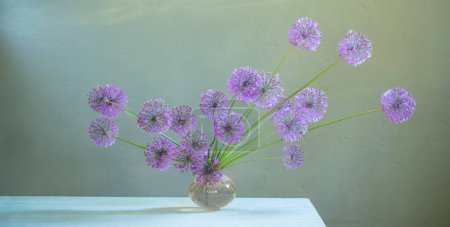Foto de Ramo de cebollas decorativas con flores en un jarrón de vidrio - Imagen libre de derechos