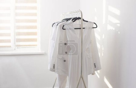 female white capsule summer wardrobe in  white room