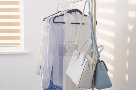 Photo for Female white and blue capsule summer wardrobe in  white room - Royalty Free Image