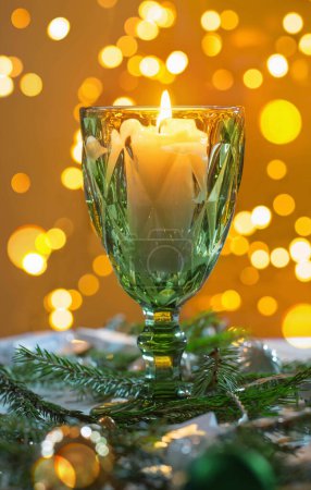 Photo for Christmas still life with branch of fir, candles and lights - Royalty Free Image