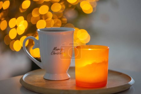 Photo for Cup with hot drink on background christmas tree - Royalty Free Image