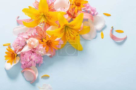Photo for Beautiful summer flowers on blue  paper background - Royalty Free Image