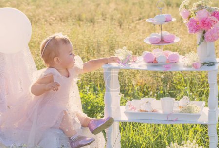 Photo for Little girl celebrates her first birthday on sunny summer day - Royalty Free Image