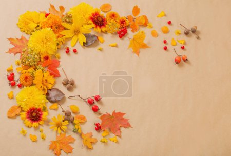 Photo for Autumn flowers and leaves on  paper background - Royalty Free Image
