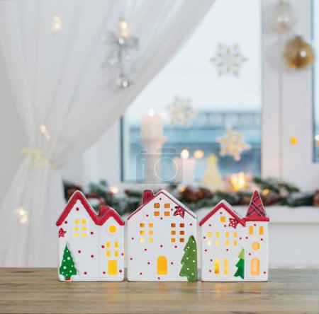 Foto de Casas de juguete de Navidad en el fondo de la ventana decorada - Imagen libre de derechos