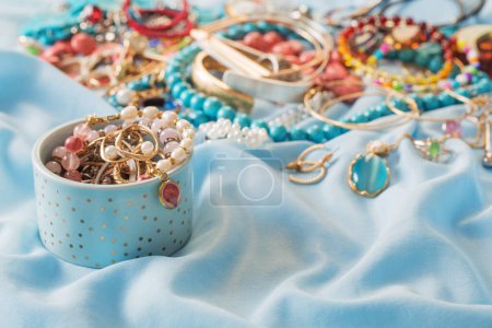 Photo for Different women's jewelry on blue fabric - Royalty Free Image