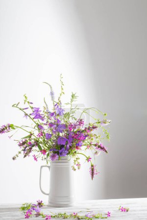 Photo for Summer wild  flowers  in white jug on white background - Royalty Free Image
