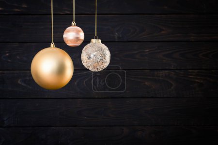 Photo for Christmas balls hanging  on  dark  wooden background - Royalty Free Image