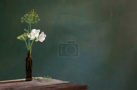 Photo for Unusual bouquet of dill and orchid on  old vintage background - Royalty Free Image