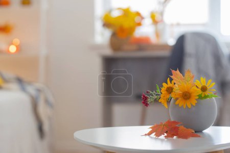 Photo for Beautiful autumnal bouquet with flowers and leaves at home - Royalty Free Image