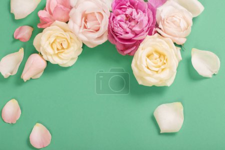 Téléchargez les photos : Belles roses sur fond de papier vert - en image libre de droit