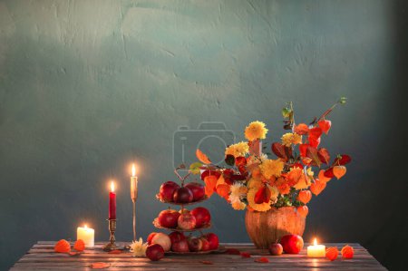 Photo for Beautiful autumnal  bouquet on wooden table on dark wall - Royalty Free Image
