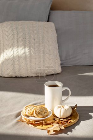 Photo for Cup of coffee on wooden tray on bed in cozy bedroom - Royalty Free Image