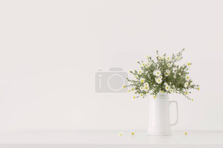 Photo for White flowers in white ceramic vase in white interior - Royalty Free Image